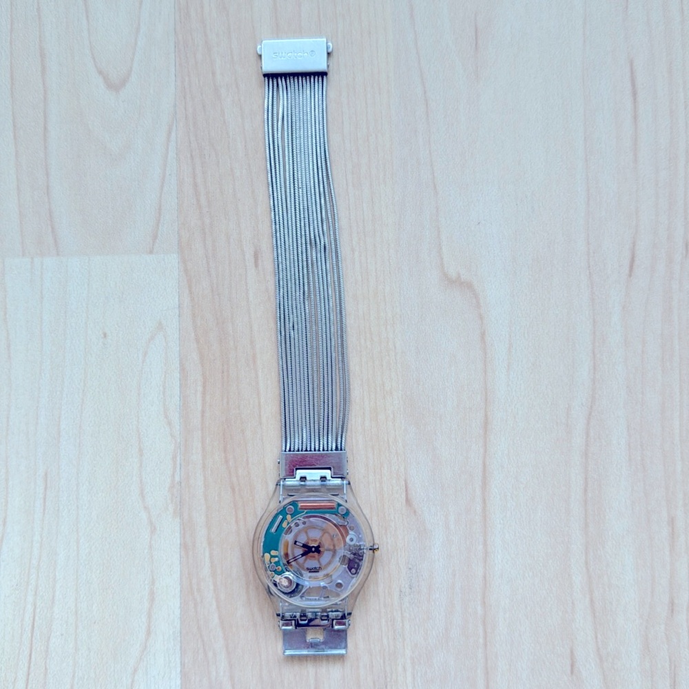 Swatch ultra thin watch has an silver bracelet